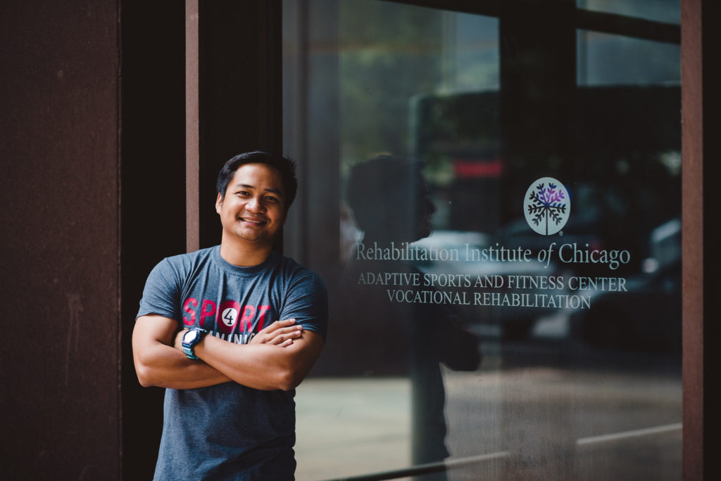 JP Maunes, a Filipino deaf rights advocate, stands in front of the Rehabilitation Institute of Chicago